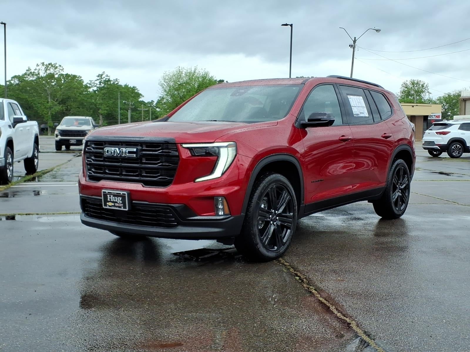2026 GMC Acadia Elevation in Volcanic Red Tintcoat — front three-quarter view